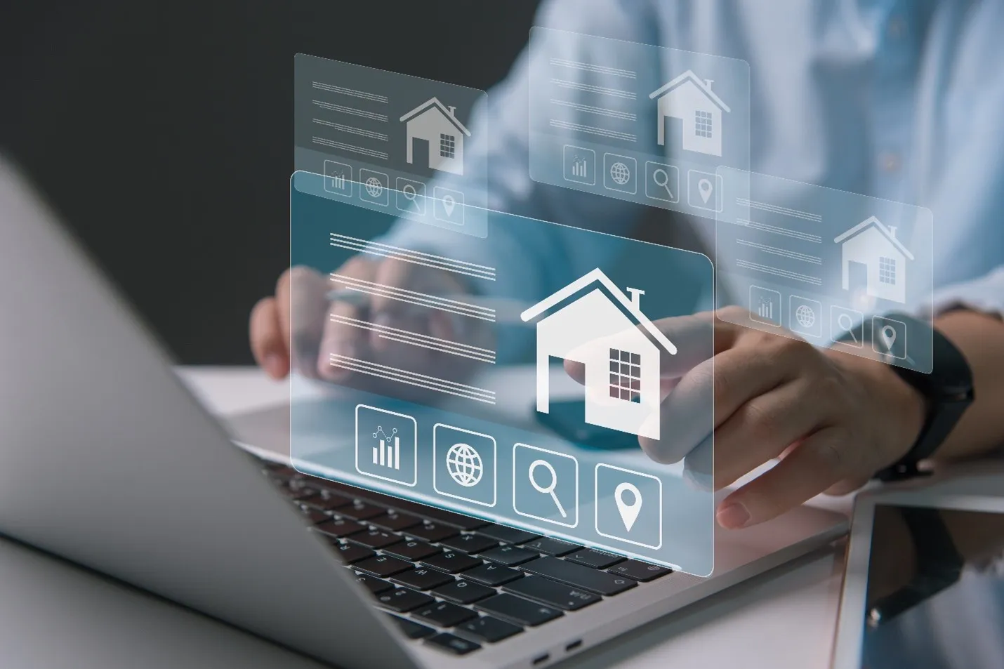 a person sits at a laptop looking at home listings 