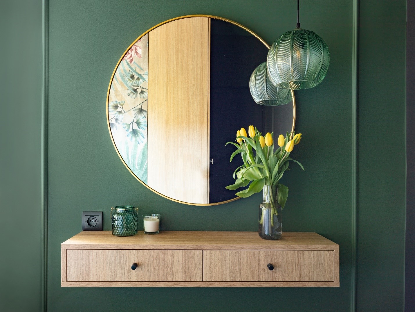 a staged entryway painted green with flowers and glass art